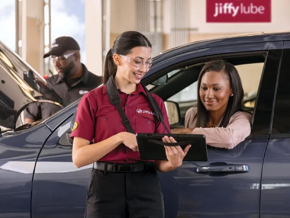 Jiffy Lube technician reviewing service with a customer